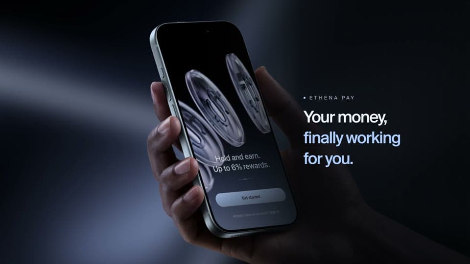 Ethena Pay launch film frame with a hand-held phone and the line Your money, finally working for you